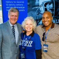 President Tom and Marcia Haas posing with a guest at the Jamie Hosford Football Center dedication.